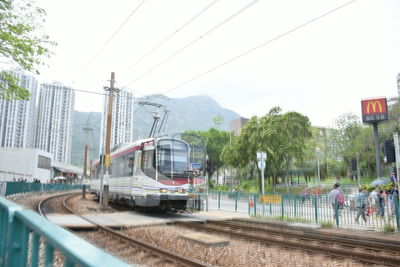 Train on railroad tracks in city against sky