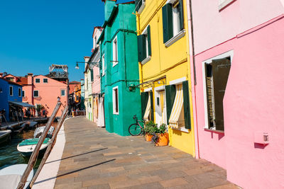 Footpath amidst buildings in city