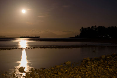 Scenic view of lake against sky at sunset