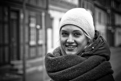 Portrait of smiling young woman standing on street