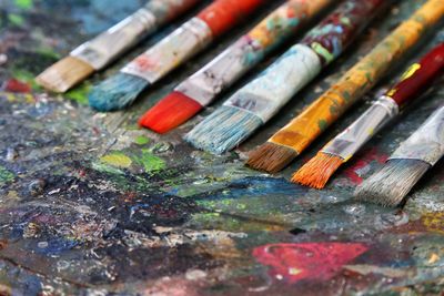 Close-up of paintbrushes on dirty table