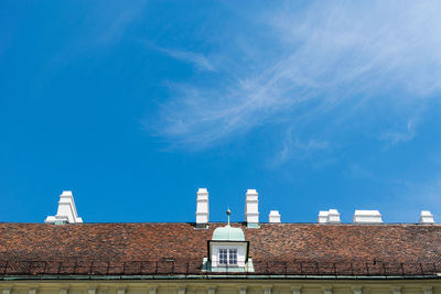 Low angle view of houses against blue sky