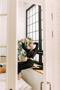 Portrait of woman sitting by window