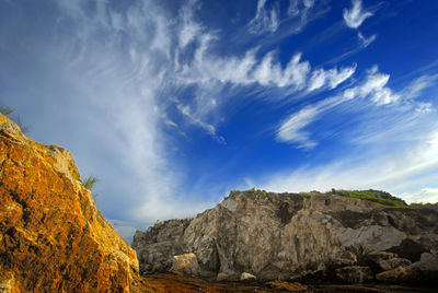 Low angle view of rock formations against sky