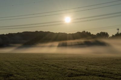 Scenic view of field against sky during sunset