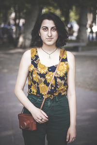 Portrait of young woman standing outdoors