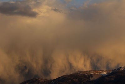 Rainstorm highlighted by a sunset in central utah as it goes over monroe mountain.