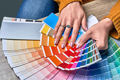 High angle view of woman holding multi colored umbrellas