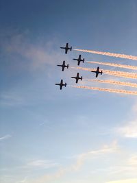 Low angle view of airshow against sky