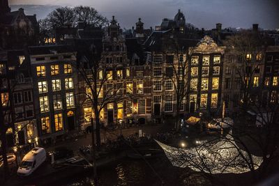 Illuminated city against sky at night