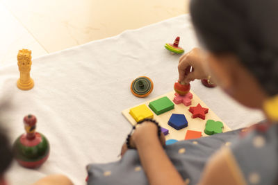 High angle view of woman hand on table at home