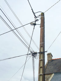 Low angle view of electricity pylon against sky