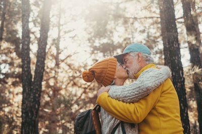 Rear view of woman standing in forest