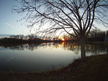 Scenic view of lake against sky at sunset