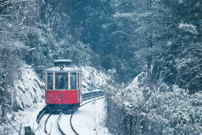 View of red car on snow covered mountain