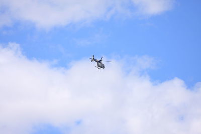 Low angle view of airplane flying in sky