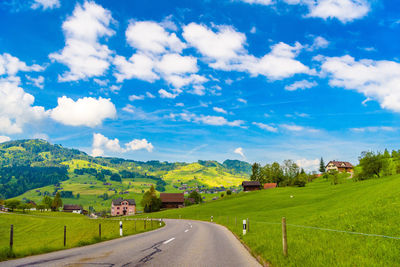 Road amidst landscape against sky