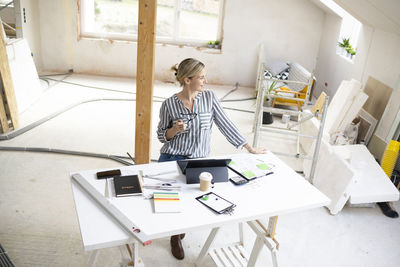 Portrait of young woman working at home