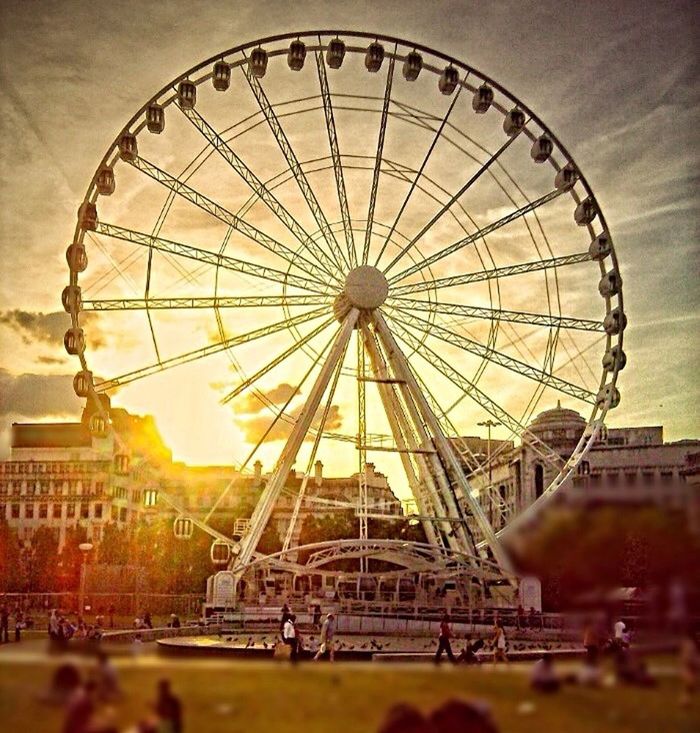 built structure, architecture, ferris wheel, amusement park, metal, circle, amusement park ride, arts culture and entertainment, building exterior, low angle view, sky, day, outdoors, water, metallic, no people, focus on foreground, famous place, travel destinations, pattern