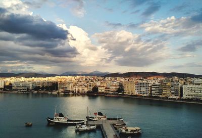 High angle view of bay and buildings against sky