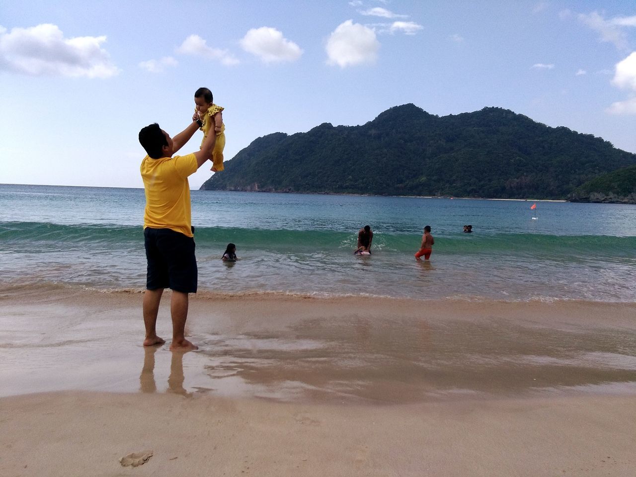 PEOPLE ENJOYING ON BEACH AGAINST SKY