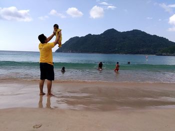 People on beach against sky