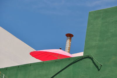 Low angle view of flag against blue sky