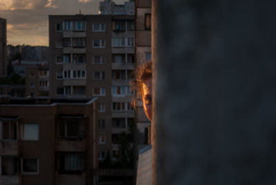 Buildings against cloudy sky at dusk