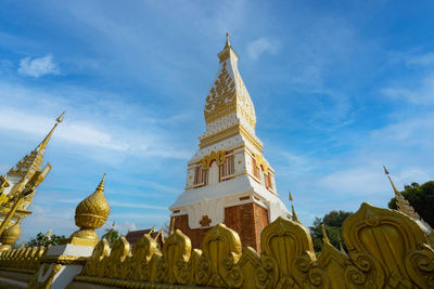 The pagoda of wat phra that panom temple in nakhon phanom in cloudy blue sky day with sunlight