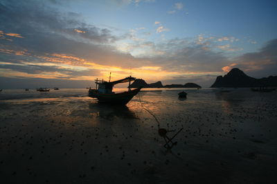 Silhouette boat on sea against sky during sunset