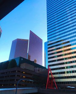 Low angle view of skyscraper against clear blue sky