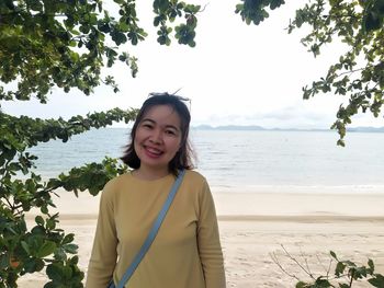 Portrait of smiling young woman on beach