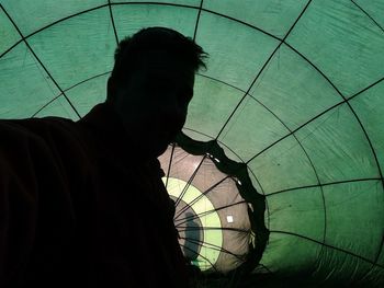 Silhouette man by hot air balloon