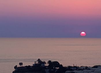 Scenic view of sea against clear sky during sunset