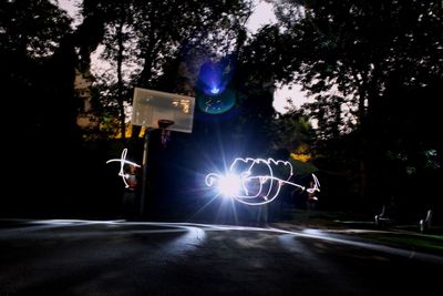 Road along trees at night