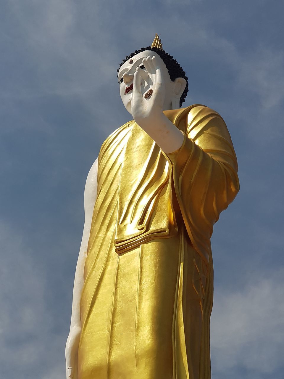 statue, low angle view, human representation, male likeness, sculpture, sky, religion, spirituality, cloud - sky, art and craft, gold colored, day, no people, outdoors