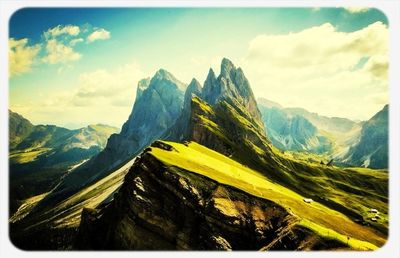 Scenic view of mountains against cloudy sky