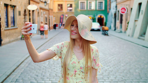 Rear view of woman standing in city