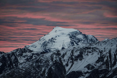 Snow covered mountain against sky during sunset