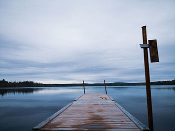 Pier over lake against sky