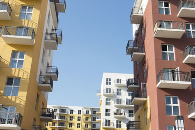 Low angle view of buildings against blue sky