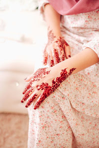 Midsection of woman standing on hand