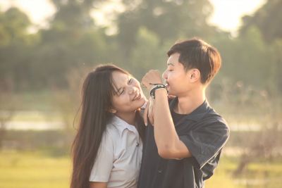 Smiling couple embracing outdoors