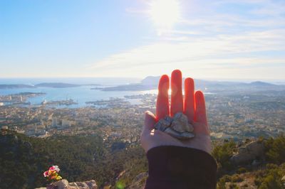 Woman's hand against sky