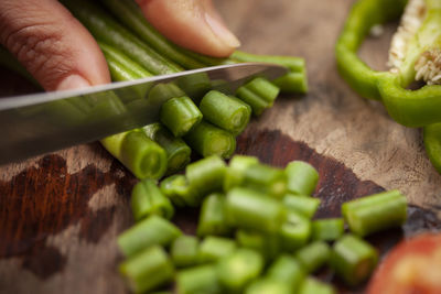 Close-up of person preparing food on cutting board