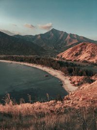 Scenic view of lake and mountains against sky