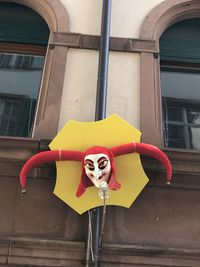 Yellow and red umbrella on building