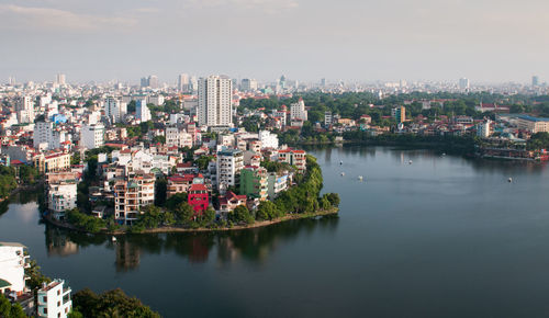 High angle view of the city of hanoi in vietnam with buildings by river against sky