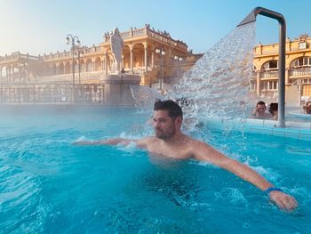 Portrait of man swimming in pool