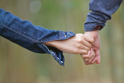 Close-up of people holding hands